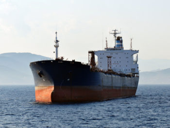 A massive cargo ship floating on a calm sea
